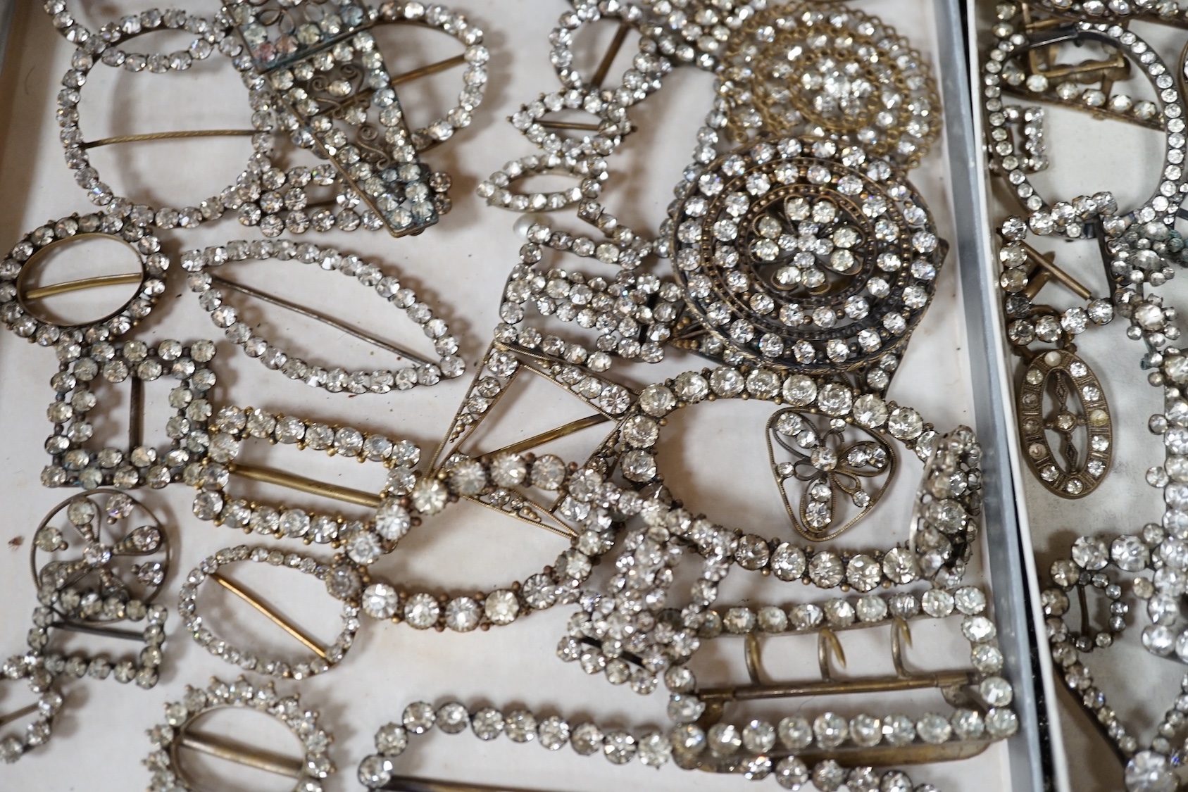 A large quantity of assorted white paste set buckles and brooches.